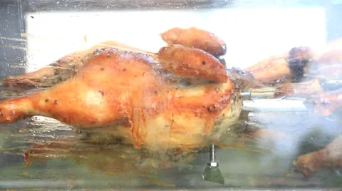Grilled Chicken rotating on a skewer. Stock Footage 39476932