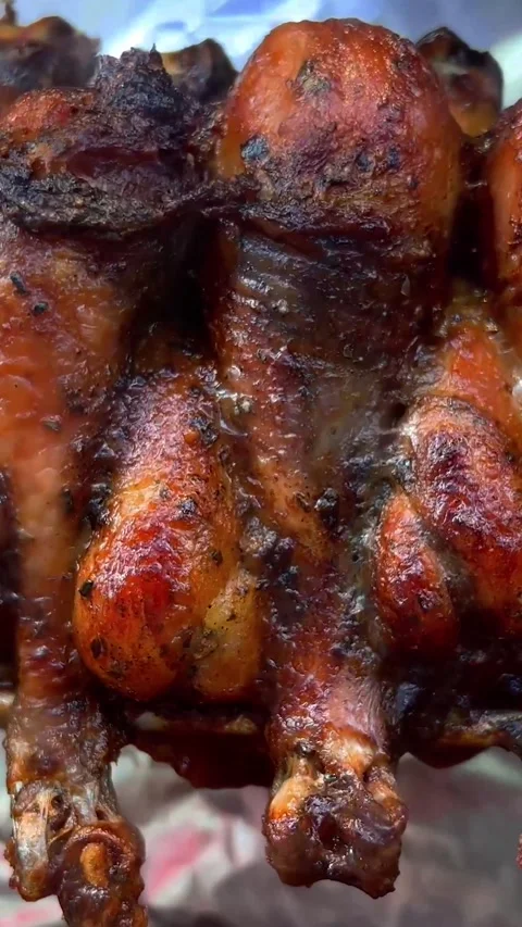 Grilled chicken spins on spit. Process of preparing fatty fried fast food Stock Footage 278336523