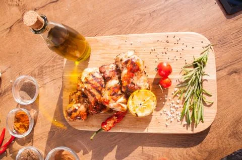 Grilled chicken steak with arugula and olive oil. Meat with pepper and herbs. Stock Photos