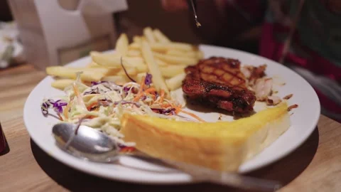 Grilled chicken steak served with crispy French fries, creamy coleslaw, and.. Stock Footage 344029669