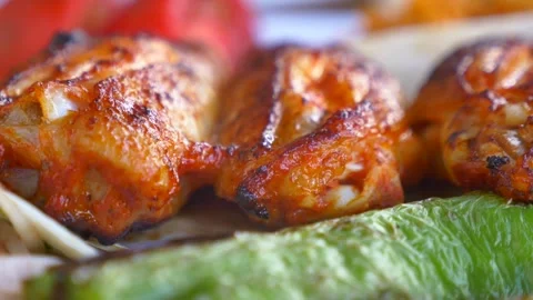 Grilled chicken wings served with roasted green peppers and onions in a cin.. Stock Footage 332044478