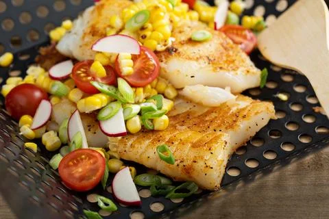 Grilled cod with summer vegetables Stock Photos