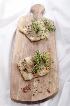Grilled cod on a wooden board Stock Photos