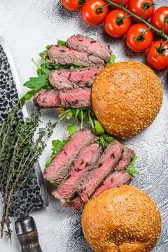 Grilled cold cuts roast beef burger sandwich with arugula and spinach. White Stock Photos