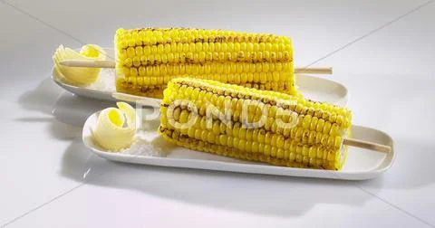 Grilled corn on the cob with butter and salt Stock Photos