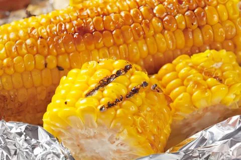 Grilled corn on the cob with foil Fotos de archivo