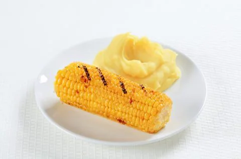 Grilled corn on the cob with mashed potatoes Stock Photos
