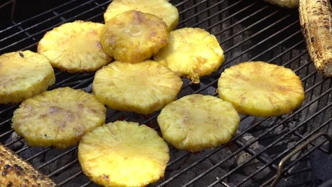 Grilled Corn &amp; Pineapple on the Grill. Juicy fruits cooking on the grill. Stock Footage 74756452