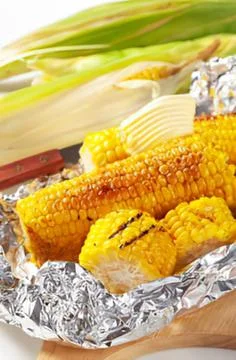 Grilled corn on tin foil with spices Stock Photos
