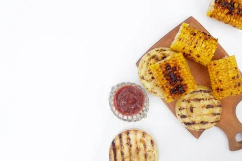 Grilled corn vegetables on a white background, copy space, flatlay Stock Photos