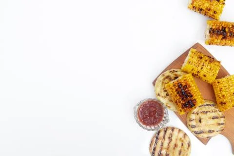 Grilled corn vegetables on a white background, copy space, flatlay Stock Photos