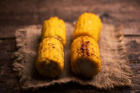 Grilled corn on wooden table Stock Photos