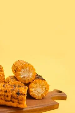 Grilled corn on a yellow background, copy space Stock Photos