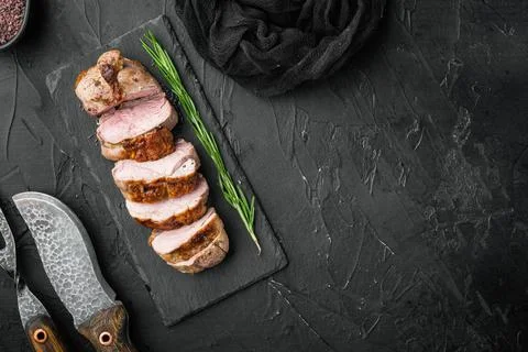 Grilled duck meat, on stone serving board, on black stone background, top vie Foto stock