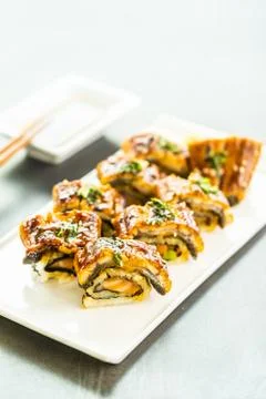 Grilled eel or unagi fish sushi maki roll with sweet sauce Stock Photos