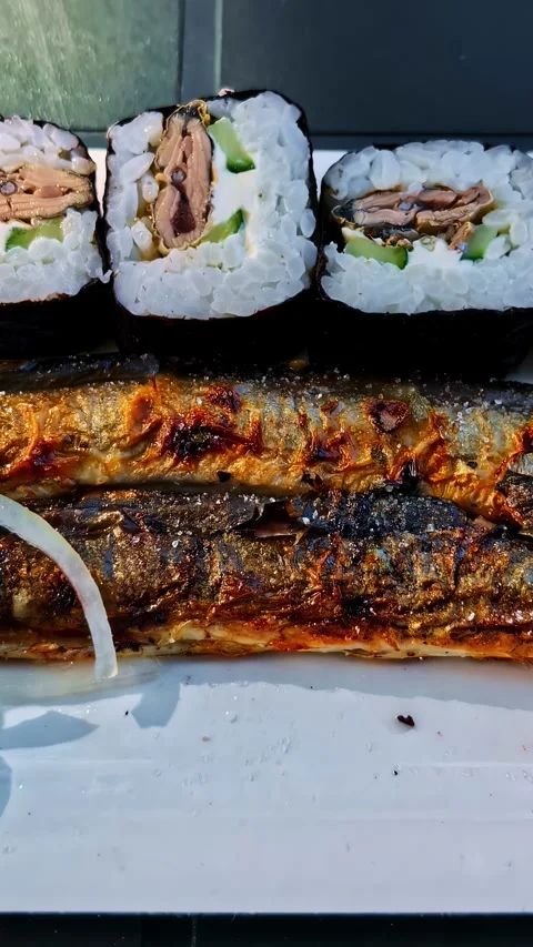 Grilled Fish and Sushi Rolls on a White Plate Видео 336333597
