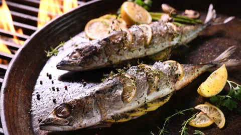 Grilled fish and various vegetables in iron plate Stock Footage 132863247