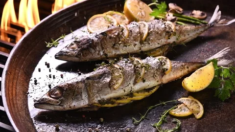 Grilled fish and various vegetables in iron plate Stock Footage 145186738