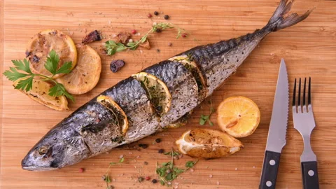 Grilled fish and various vegetables on a chopping board Stock Footage 145189262