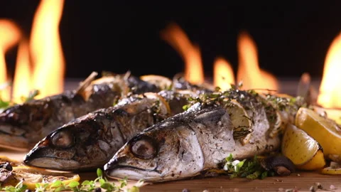 Grilled fish and various vegetables in iron plate Stock Footage 145675459