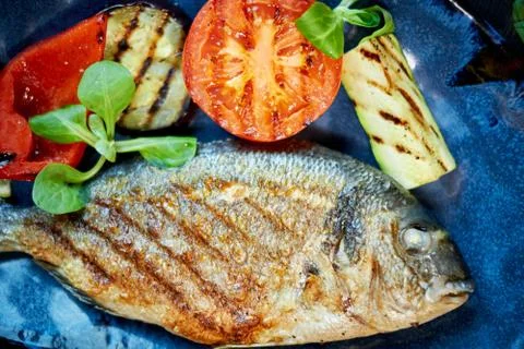 Grilled Fish dish - roasted fish and vegetables jpg Stock Photos