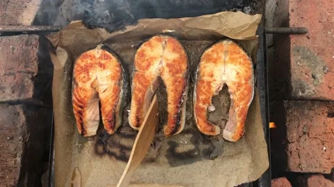 Grilled fish on fire in the courtyard of the house Stock Footage 150329368