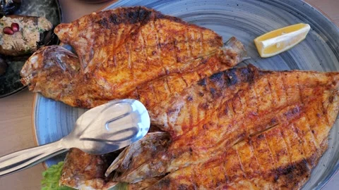 Grilled fish, fried sea bass on plate in restaurant, seafood healthy eating, top Stock Footage 231334341