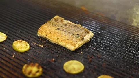 Grilled fish with mashed potato and veggies on top served on a white plate Stock Footage 302906201