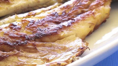 Grilled fish on the plate close up pan shot. Well done cook.  Stock Footage 80314607