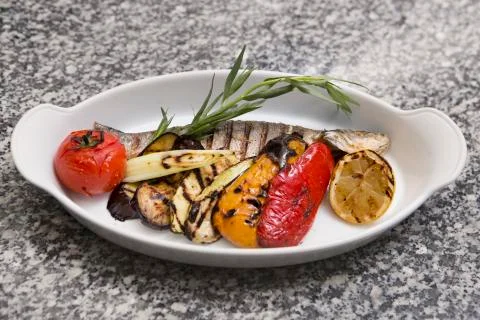 Grilled fish with vegetables Stock Photos