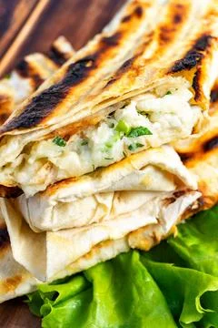 Grilled flatbread rolls filled with fresh vegetables and herbs Stock Photos