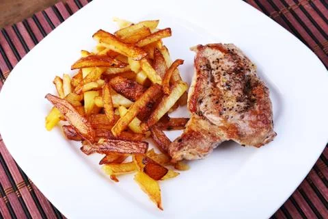 Grilled free-range beef steak with potato free, fresh tomatoes and sauce on a Stock Photos