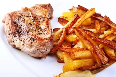 Grilled free-range beef steak with potato free, fresh tomatoes and sauce on a Stock Photos