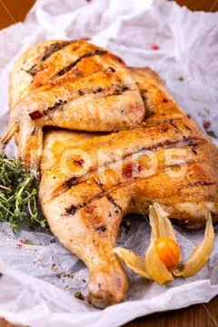 Grilled fried roast Chicken tobacco on cutting board with herb on wooden Stock Photos