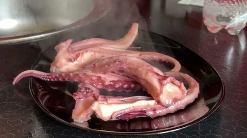 Grilled giant squid tentacles served with lemon and herbs as a gourmet seafood Stock Footage 345171797