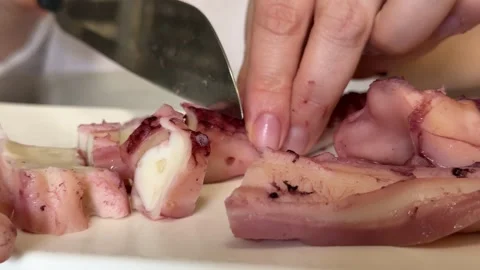 Grilled giant squid tentacles served with lemon and herbs as a gourmet seafood Stock Footage 345182759