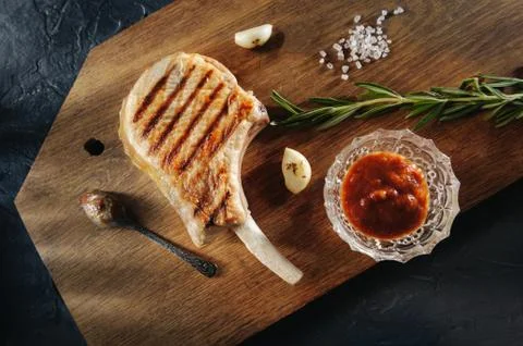 Grilled grilled steak on the bone with baking and garlic and coarse salt on a 库存照片