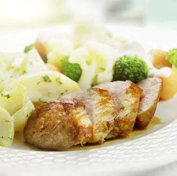 Grilled ham served  with cauliflower broccoli carrot and potatoes Stock Photos