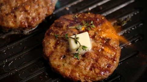 Grilled hamburgers on the grill. Burger cutlet is cooked in a grill pan, thyme Stock Footage 130751253