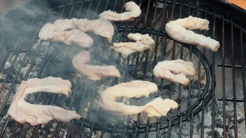 Grilled intestines to crispy texture. Chinchulin is the small intestine of an Stock Footage 320954704