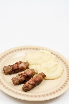 Grilled kebabs in bacon with mashed potatoes Stock Photos