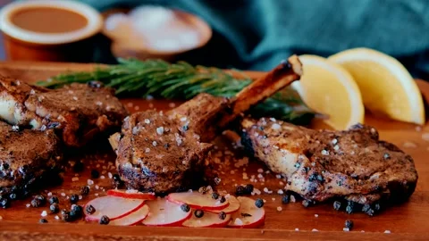 Grilled lamb chops with lemon and rosemary roasted with spices and sauce Stock Footage 171717619