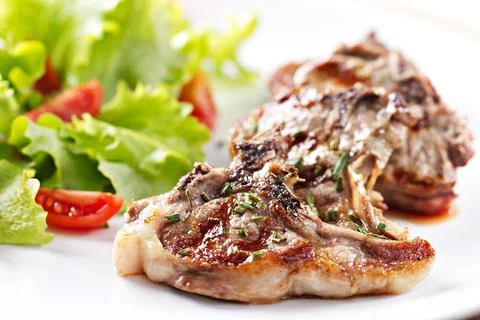 Grilled lamb chops with mixed salad. High quality photo Stock Photos