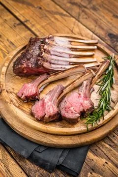 Grilled lamb chops, mutton meat cutlets steaks on wooden board. wooden back.. Stock Photos