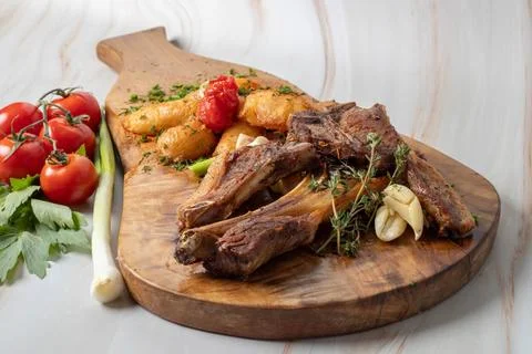 Grilled lamb chops served with roasted potatoes, garlic Stock Photos
