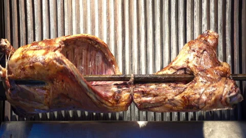 Grilled lamb grill rotates on a spit. Stock Footage 108502777