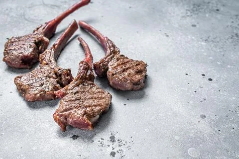 Grilled lamb mutton meat chops steaks. Gray background. Top view. Copy space Stock Photos