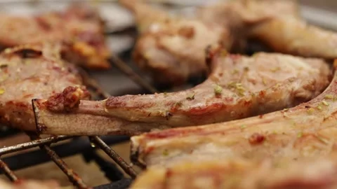 Grilled lamb ribs. Hot rack of lamb with spices and condiments. Video stock 242497788