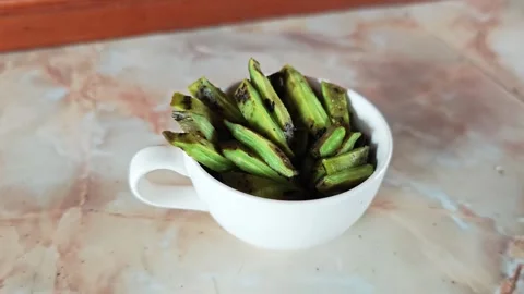 Grilled luffa or broken bones tree fruit slices in white cup. Vídeos de archivo 341872442