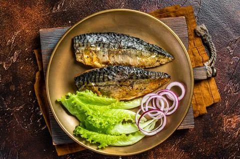 Grilled mackerel scomber fish fillets with garnish in a plate. Dark backgro.. Stock Photos